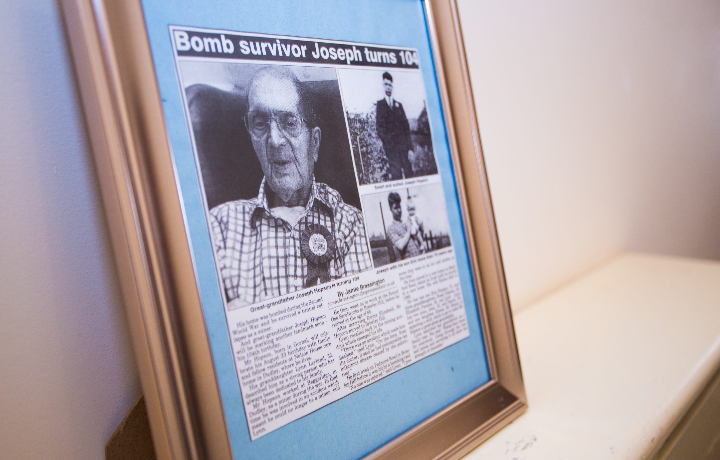 A framed newspaper about Joseph Hopson turning 104 at Nelson House